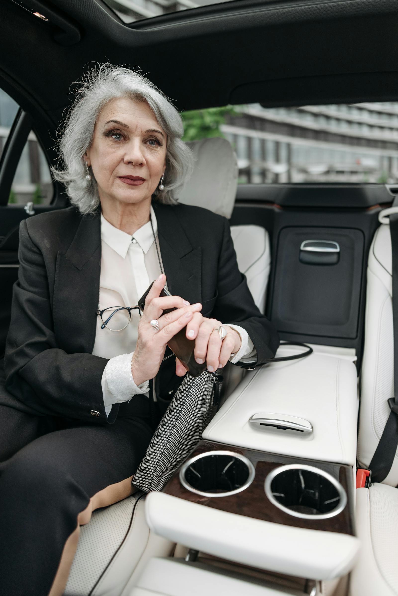 Senior executive exiting luxury black car